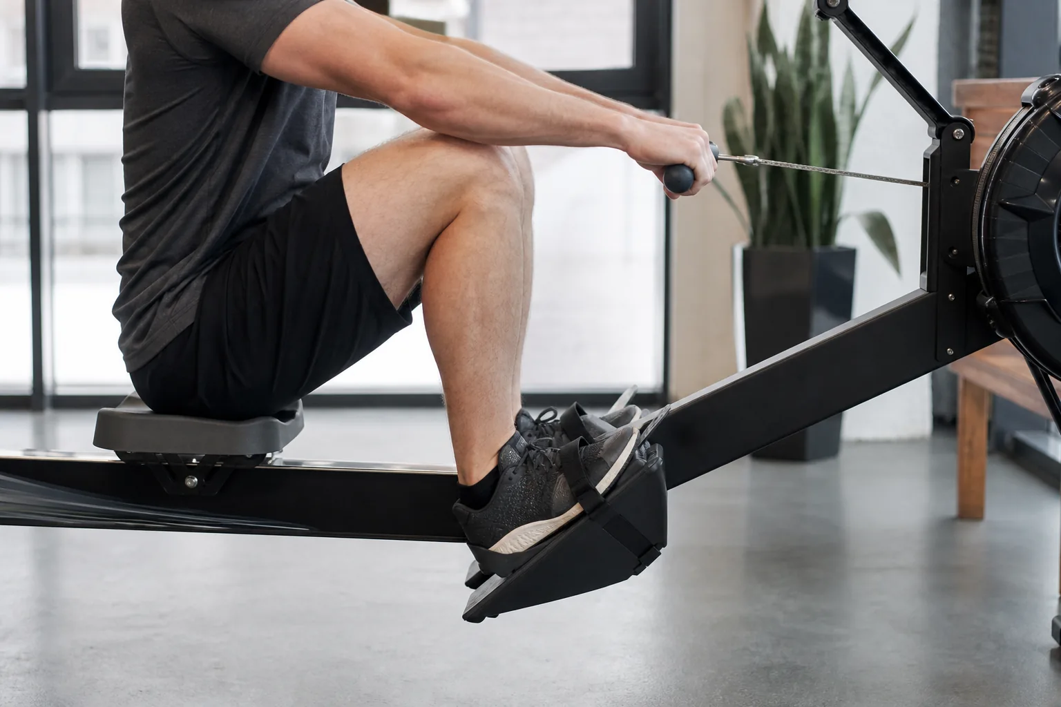 Side view of a rower at a comfortable catch with shins near vertical and space between seat and heels