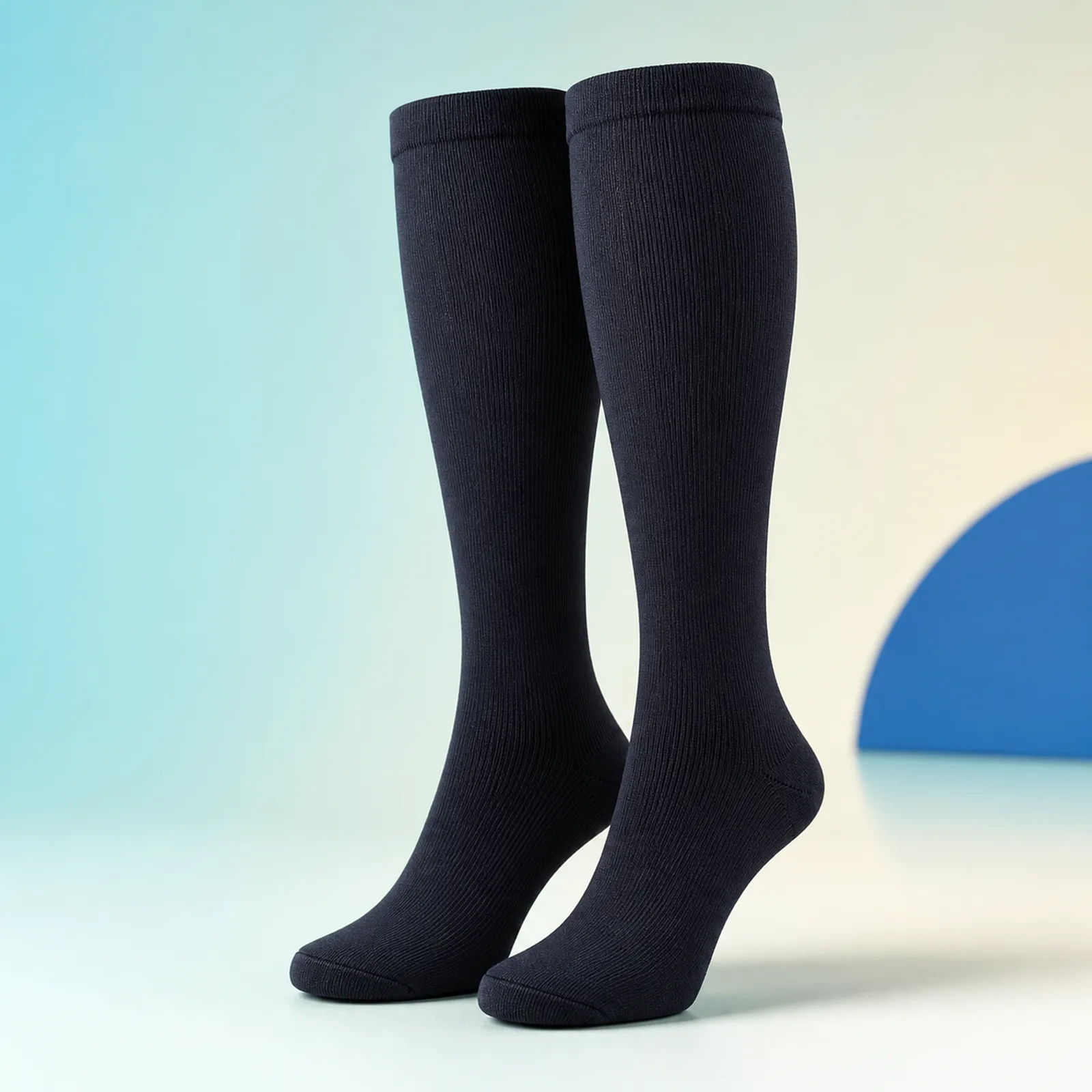 Pair of navy FlexiKnee Everyday Compression Socks on a clean premium background
